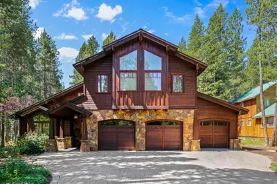 a wooden house with a garage at Majestic Woods at Tahoe Donner - High End Craftsman w Game Room, Hot Tub, Amenity Access in Truckee