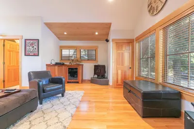 a living room with a couch and a chair at Lupine Lodge at Tahoe Park on the West Shore - Hot Tub, Beach Access, Near Ski Resorts! in Tahoe City