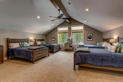 a bedroom with two beds and a ceiling fan at Mountain Jewel in Tahoe Donner - Beautiful 4 Bedroom w Hot tub, Access to HOA Amenities in Truckee