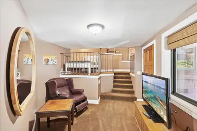 a living room with a chair and a tv at On the Edge at Alpine Meadows - Fireplace- Mountain Views- Great Location! Shuttle Service! in Olympic Valley