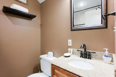 a bathroom with a toilet and a sink and a mirror at On the Edge at Alpine Meadows - Fireplace- Mountain Views- Great Location! Shuttle Service! in Olympic Valley