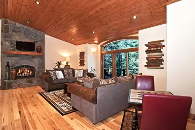 a living room with a couch and a fireplace at Rooney Ridge - Luxury 2600 Sq Ft, Cozy Fireplace, Family Room, Ping Pong Table! in Carnelian Bay