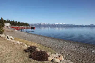 a rocky beach with a large body of water at Rooney Ridge - Luxury 2600 Sq Ft, Cozy Fireplace, Family Room, Ping Pong Table! in Carnelian Bay