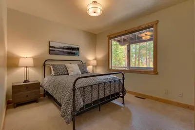 a bedroom with a bed and a window at Paradise in the Pines - Luxury Home in Quite Neighborhood, Wooded Views, Short Drive to Skiing in Carnelian Bay