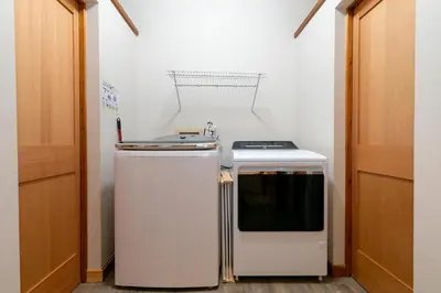 a small kitchen with a stove and a refrigerator at Shady Pines at Tahoe Donner- Serene Forest Retreat, 2 Gas Fireplaces, Sauna in Truckee