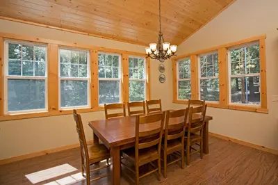 a dining room with a wooden table and chairs at Sans Souci Terrace on the West Shore- 4 BR Cabin, Avail as a Ski Lease, Near Skiing! in Homewood