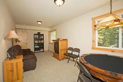 a living room with a ping pong table at Sans Souci Terrace on the West Shore- 4 BR Cabin, Avail as a Ski Lease, Near Skiing! in Homewood
