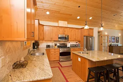 a kitchen with wooden cabinets and a counter top at Sans Souci Terrace on the West Shore- 4 BR Cabin, Avail as a Ski Lease, Near Skiing! in Homewood