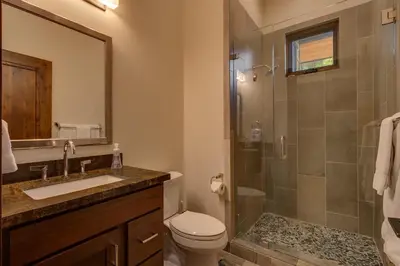 a bathroom with a shower and a toilet and a sink at Sage Hen at Grays Crossing - Gorgeous 4BR 4BA Home w Private Hot Tub in Truckee