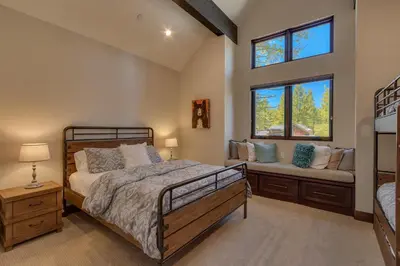 a bedroom with a large bed and a window at Sage Hen at Grays Crossing - Gorgeous 4BR 4BA Home w Private Hot Tub in Truckee