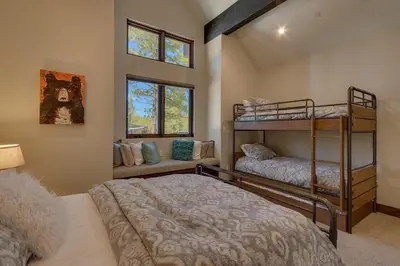 a bedroom with two bunk beds and a couch at Sage Hen at Grays Crossing - Gorgeous 4BR 4BA Home w Private Hot Tub in Truckee