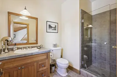 a bathroom with a shower and a toilet and a sink at Silverado Lodge at Palisades - 4BR w Private Hot Tub & Ski Shuttle in Olympic Valley
