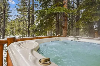 a hot tub in the woods in the snow at Ski View at Tahoe Donner - Stunning 4 BR w Private Hot Tub - HOA Amenities in Truckee