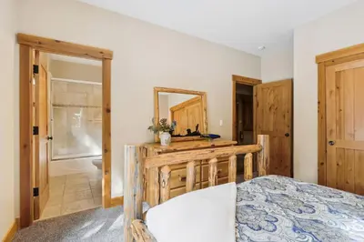 a bedroom with a bed and a mirror at Ski View at Tahoe Donner - Stunning 4 BR w Private Hot Tub - HOA Amenities in Truckee
