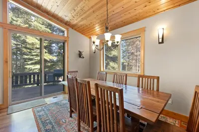a dining room with a wooden table and chairs at Skislope Manor - Spacious Tahoe Donner 4 BR with Gorgeous Home Theater and Hot Tub in Truckee