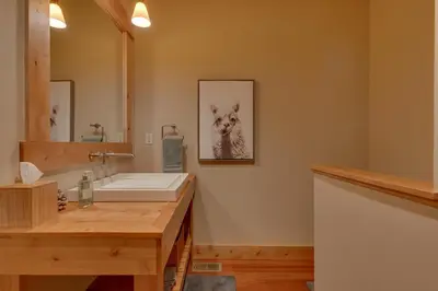 a bathroom with a sink and a mirror at Skislope Manor - Spacious Tahoe Donner 4 BR with Gorgeous Home Theater and Hot Tub in Truckee
