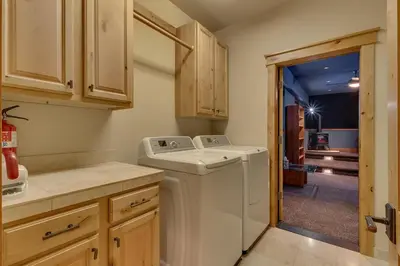 a laundry room with a washer and dryer at Skislope Manor - Spacious Tahoe Donner 4 BR with Gorgeous Home Theater and Hot Tub in Truckee