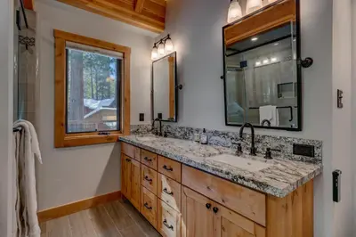 a bathroom with a sink and a mirror at Snowbird Retreat at Northstar - Beautiful 4BR with Private Hot Tub, Free Ski Shuttle, HOA Amenities in Truckee