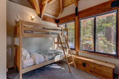 a bedroom with bunk beds in a tree house at Snowbird Retreat at Northstar - Beautiful 4BR with Private Hot Tub, Free Ski Shuttle, HOA Amenities in Truckee