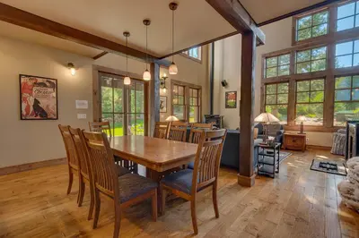 a dining room with a wooden table and chairs at Norse Hall in Tahoe Donner - Gorgeous Home with Private Hot Tub and Gourmet Kitchen in Truckee