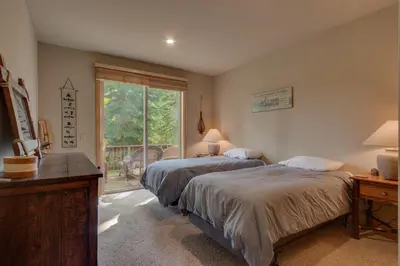 a bedroom with two beds and a window at High Altitude at Tahoe Donner - Huge 4 BR with Private Hot Tub, Pool Table, Ping Pong, HOA Amenities in Truckee