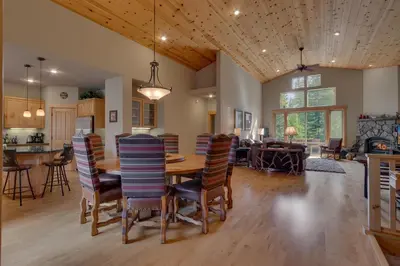 a dining room and living room with a table and chairs at High Altitude at Tahoe Donner - Huge 4 BR with Private Hot Tub, Pool Table, Ping Pong, HOA Amenities in Truckee