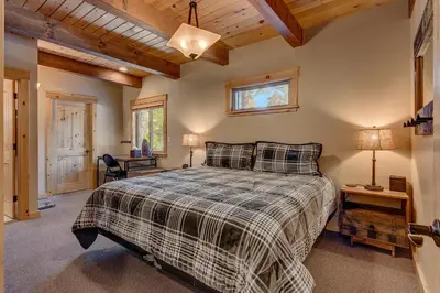 a bedroom with a bed and a desk and a window at Edelweiss Retreat- Close to Lake and Ski Resorts- Pet Friendly- Hot Tub in Tahoe City