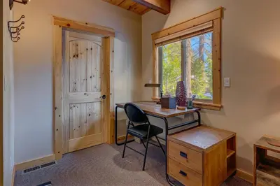 a desk and chair in a room with a window at Edelweiss Retreat- Close to Lake and Ski Resorts- Pet Friendly- Hot Tub in Tahoe City