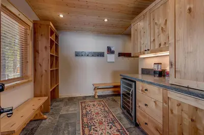 a kitchen with wooden cabinets and a counter top at Edelweiss Retreat- Close to Lake and Ski Resorts- Pet Friendly- Hot Tub in Tahoe City