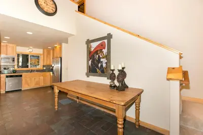 a kitchen with a wooden table in a room at Interlaken on the West Shore by Tahoe Getaways - Pet Friendly 3BR, Close to Skiing & Walk to the Lake! in Homewood