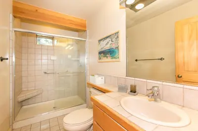 a bathroom with a sink and a toilet and a shower at Interlaken on the West Shore by Tahoe Getaways - Pet Friendly 3BR, Close to Skiing & Walk to the Lake! in Homewood