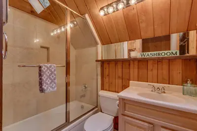 a bathroom with a toilet and a shower and a sink at Cozy Wood Cabin- Updated- Hot Tub- Fireplace- Backs to Forest in Carnelian Bay