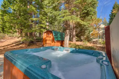 a hot tub in the backyard of a house at Cozy Wood Cabin- Updated- Hot Tub- Fireplace- Backs to Forest in Carnelian Bay