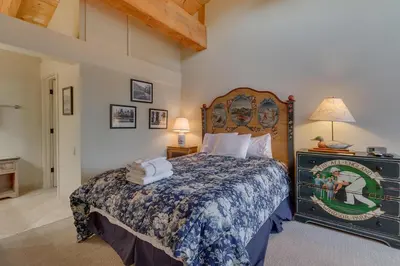 a bedroom with a bed with a large headboard at North Shore Lakeside Condo #8 by Tahoe Getaways - Updated 3 Story Condo Near Palisades Resort w HOA! in Tahoe City
