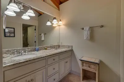 a bathroom with two sinks and a large mirror at North Shore Lakeside Condo #8 by Tahoe Getaways - Updated 3 Story Condo Near Palisades Resort w HOA! in Tahoe City