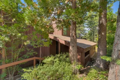 a cabin in the woods with trees at North Shore Lakeside Condo #8 by Tahoe Getaways - Updated 3 Story Condo Near Palisades Resort w HOA! in Tahoe City
