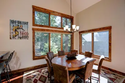 a dining room with a wooden table and chairs at North Shore Bliss by Tahoe Getaways - 3 BR plus loft & Private Hot Tub in Carnelian Bay