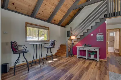 a room with a table and chairs and a staircase at Piney wood - Quiet 2 BR Loft w Private Hot Tub in Carnelian Bay