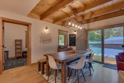a dining room with a wooden table and chairs at Olympic Valley Hideaway - Newly Remodeled Cabin with Private Hot Tub in Olympic Valley