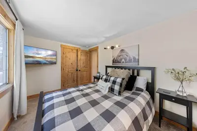 a bedroom with a bed and a window at Rustling Grove in Tahoe City - Pet-Friendly, Walking Distance to Downtown and Lake - Private Hot Tub in Tahoe City