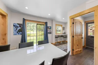 a kitchen and dining room with a table and chairs at Rustling Grove in Tahoe City - Pet-Friendly, Walking Distance to Downtown and Lake - Private Hot Tub in Tahoe City
