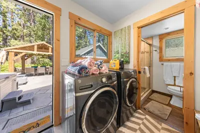 a laundry room with a washer and dryer at Rustling Grove in Tahoe City - Pet-Friendly, Walking Distance to Downtown and Lake - Private Hot Tub in Tahoe City