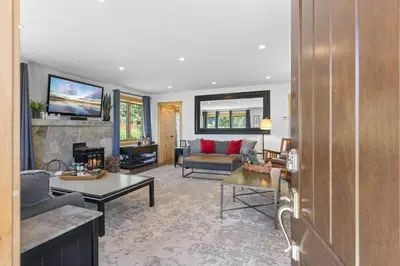 a living room with a couch and a fireplace at Rustling Grove in Tahoe City - Pet-Friendly, Walking Distance to Downtown and Lake - Private Hot Tub in Tahoe City