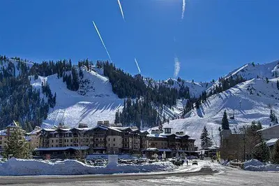a large building on a snow covered mountain at Palisades Tahoe Ski Condo by Tahoe Getaways - Remodeled 2 BR, Walking Distance to Lifts & Village in Olympic Valley