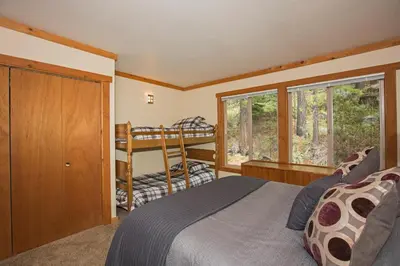 a bedroom with a bed and a bunk bed at Palisades Tahoe Ski Condo by Tahoe Getaways - Remodeled 2 BR, Walking Distance to Lifts & Village in Olympic Valley