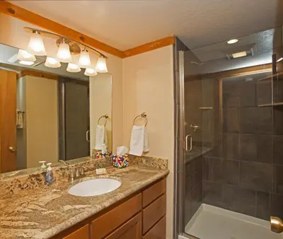 a bathroom with a sink and a shower at Palisades Tahoe Ski Condo by Tahoe Getaways - Remodeled 2 BR, Walking Distance to Lifts & Village in Olympic Valley