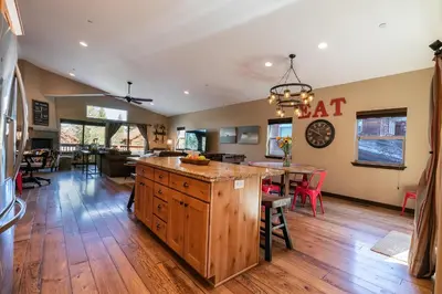 a kitchen and dining room with a eat in kitchen at Pinecrest at Winter Creek- Cozy Cabin w Hot Tub, Walk To Downtown Truckee in Truckee