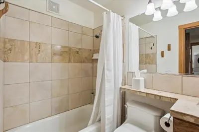 a bathroom with a tub and a toilet and a sink at Rocky Point # 4 - 2 BR Northstar Condo, Shuttle to Slopes, HOA Amenities! in Truckee