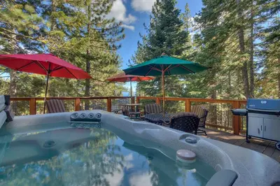 a swimming pool with umbrellas and tables and chairs at Silver Tip at Tahoe Park w HOA amenities - 3BR Pet Friendly, Hot Tub, Tahoe City in Tahoe City