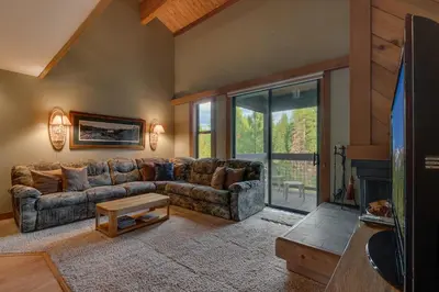 a living room with a couch and a fireplace at Silver Strike #2- Walk to Village- Ski Shuttle to Lifts in Truckee